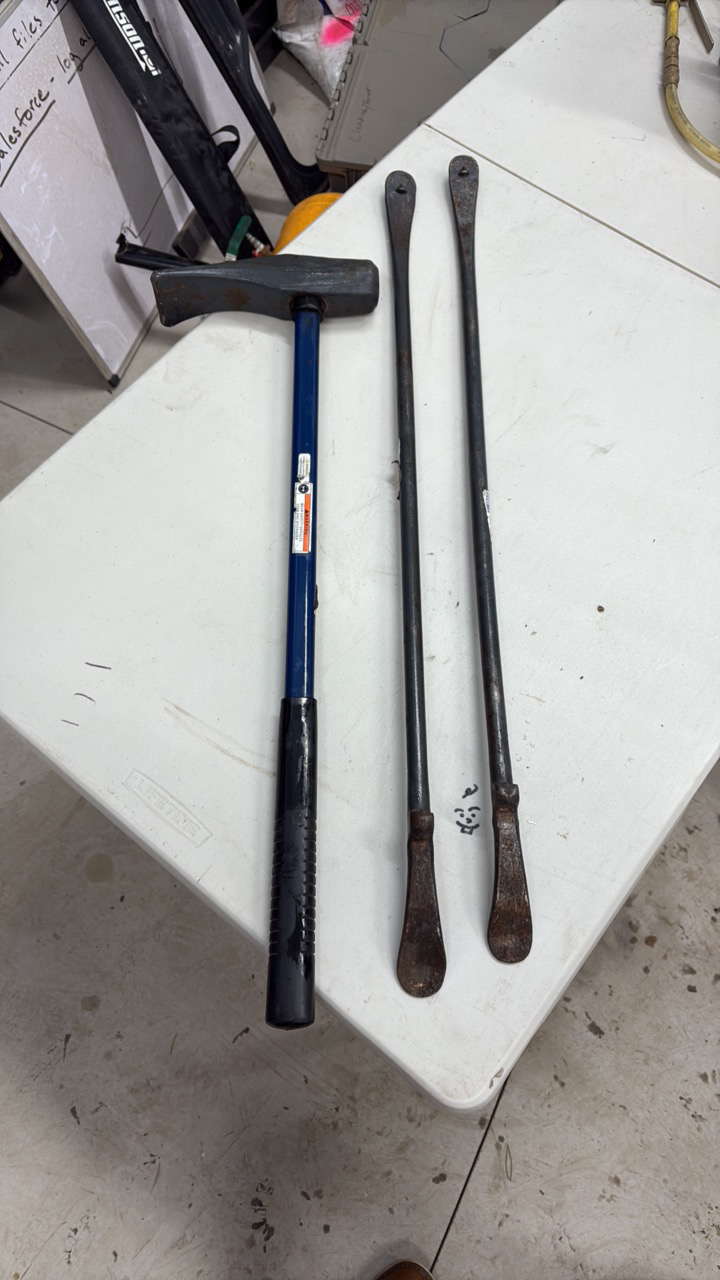 lot 45 image: (2) Tire Spoons - tire irons (1) Small sledge hammer