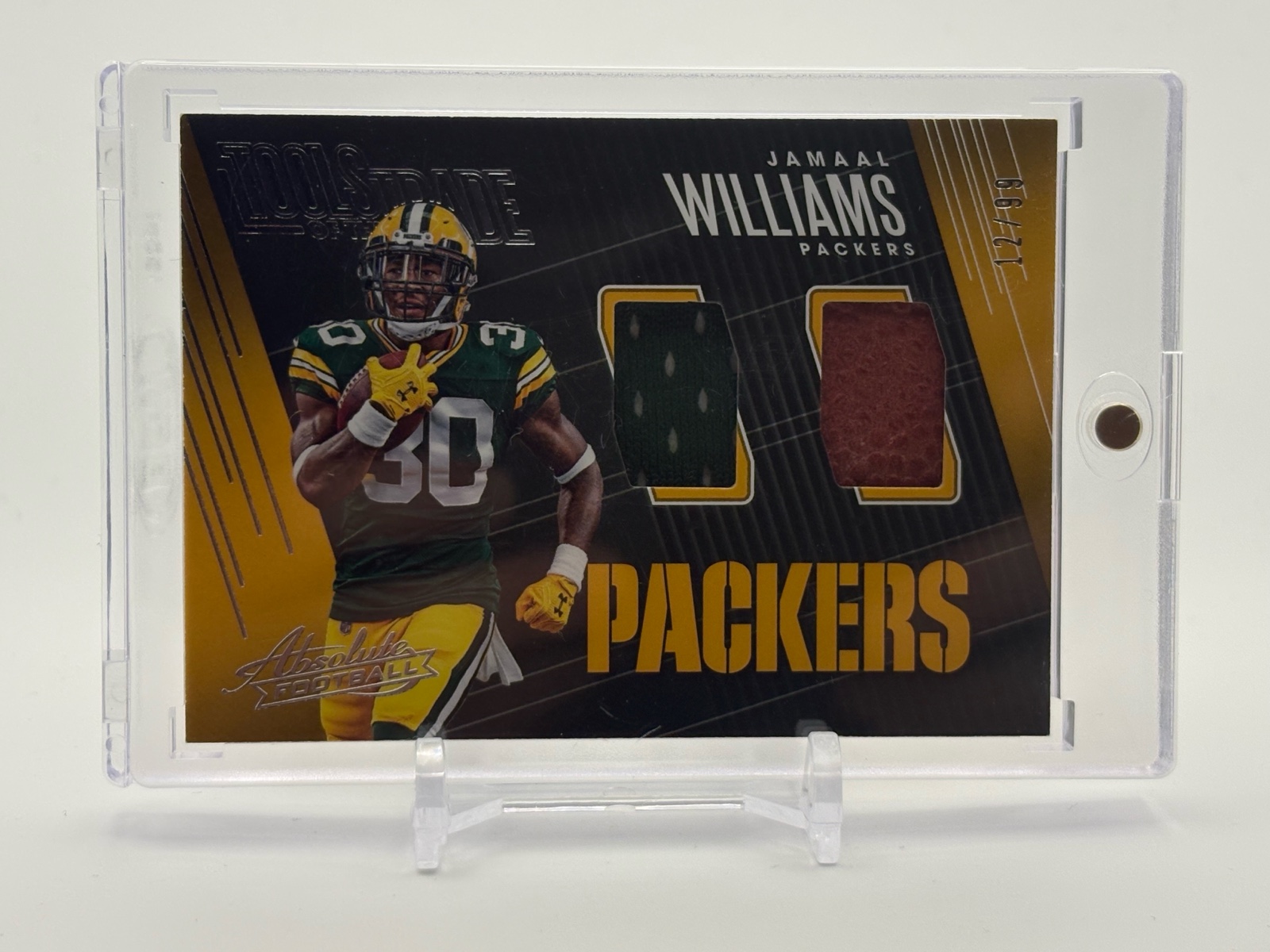 lot 395 image: 2018 Absolute Football Jamaal Williams Tools of the Trade Player Used Jersey and Football Skin Card Serial #d 1299 Green Bay Packers