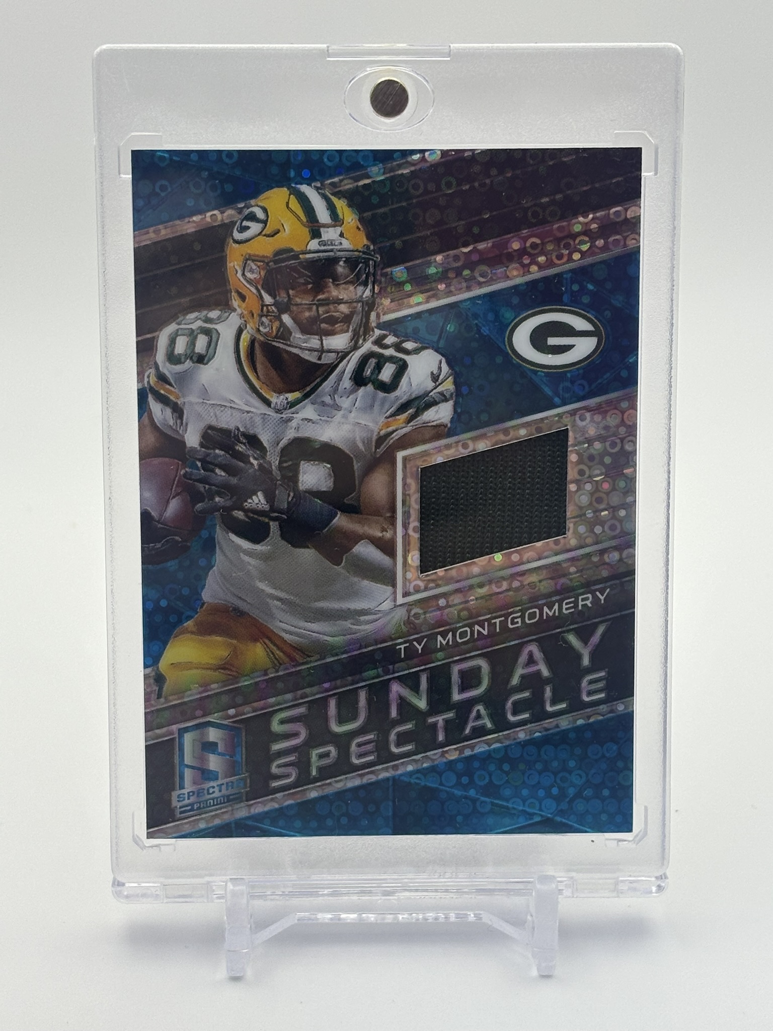lot 714 image: 2018 Panini Spectra - Sunday Spectacle Ty Montgomery #6 Neon Blue Prizm 99 Jersey Card