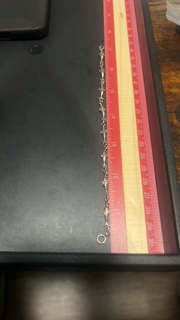 lot 99 image: Sterling silver dolphin bracelet