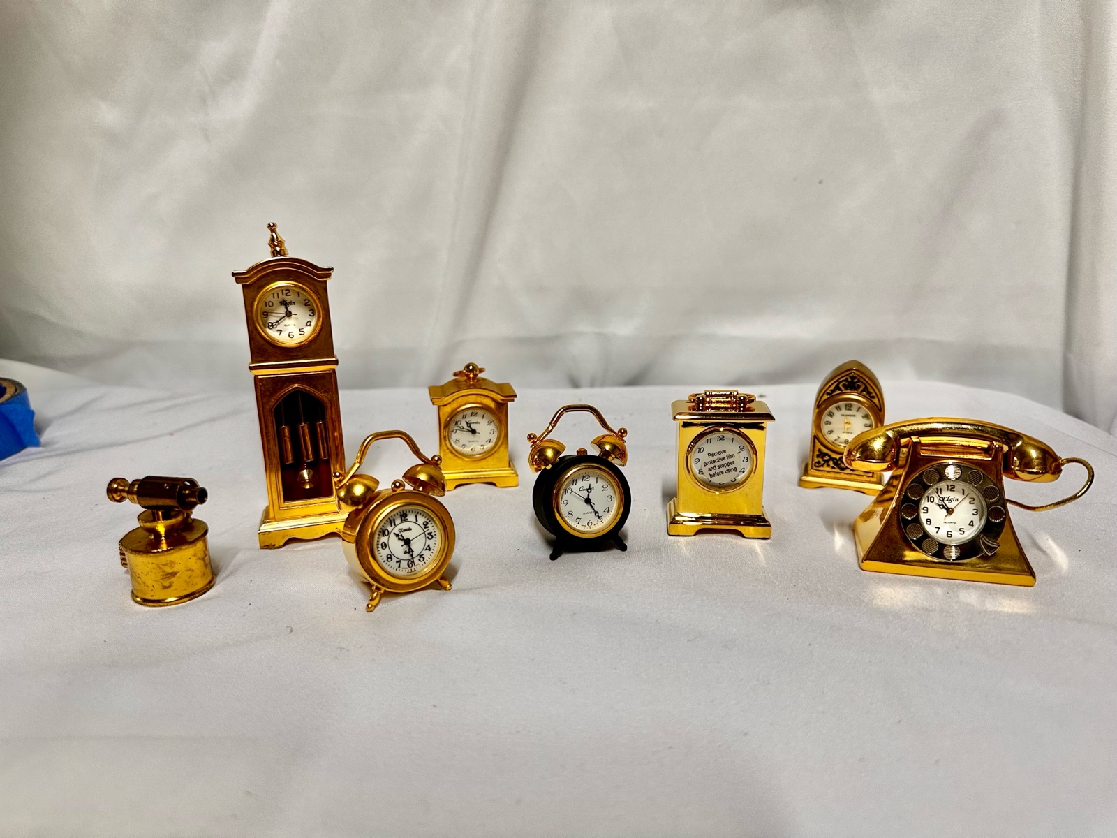 Collection of vintage gold-plated miniature clocks