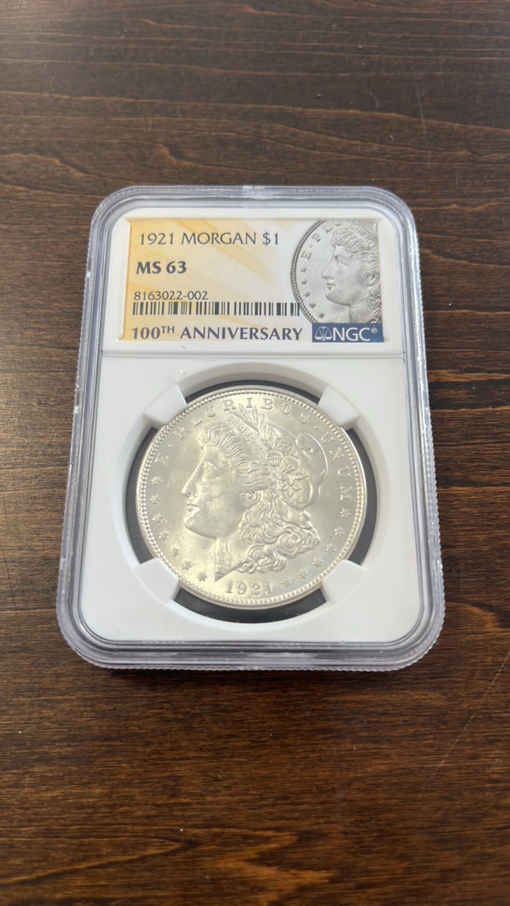 lot 5 image: 1921 MS63 Morgan 1$ coin NGC 100th anniversary banner