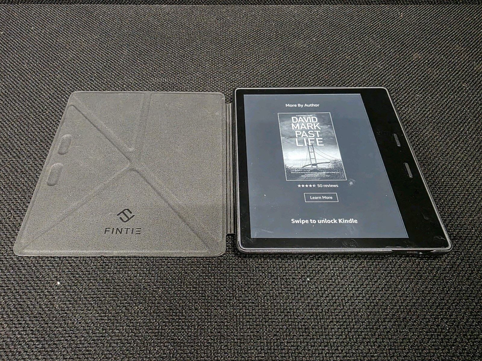 lot 122 image: Amazon Kindle Oasis e-reader with a Fintie Origami case