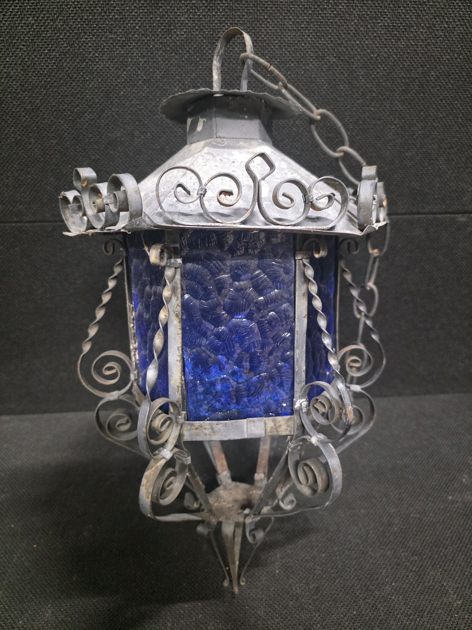 lot 167 image: Vintage Hanging Lantern featuring a Decorative Wrought Iron Frame and Textured Blue-Glass Panels