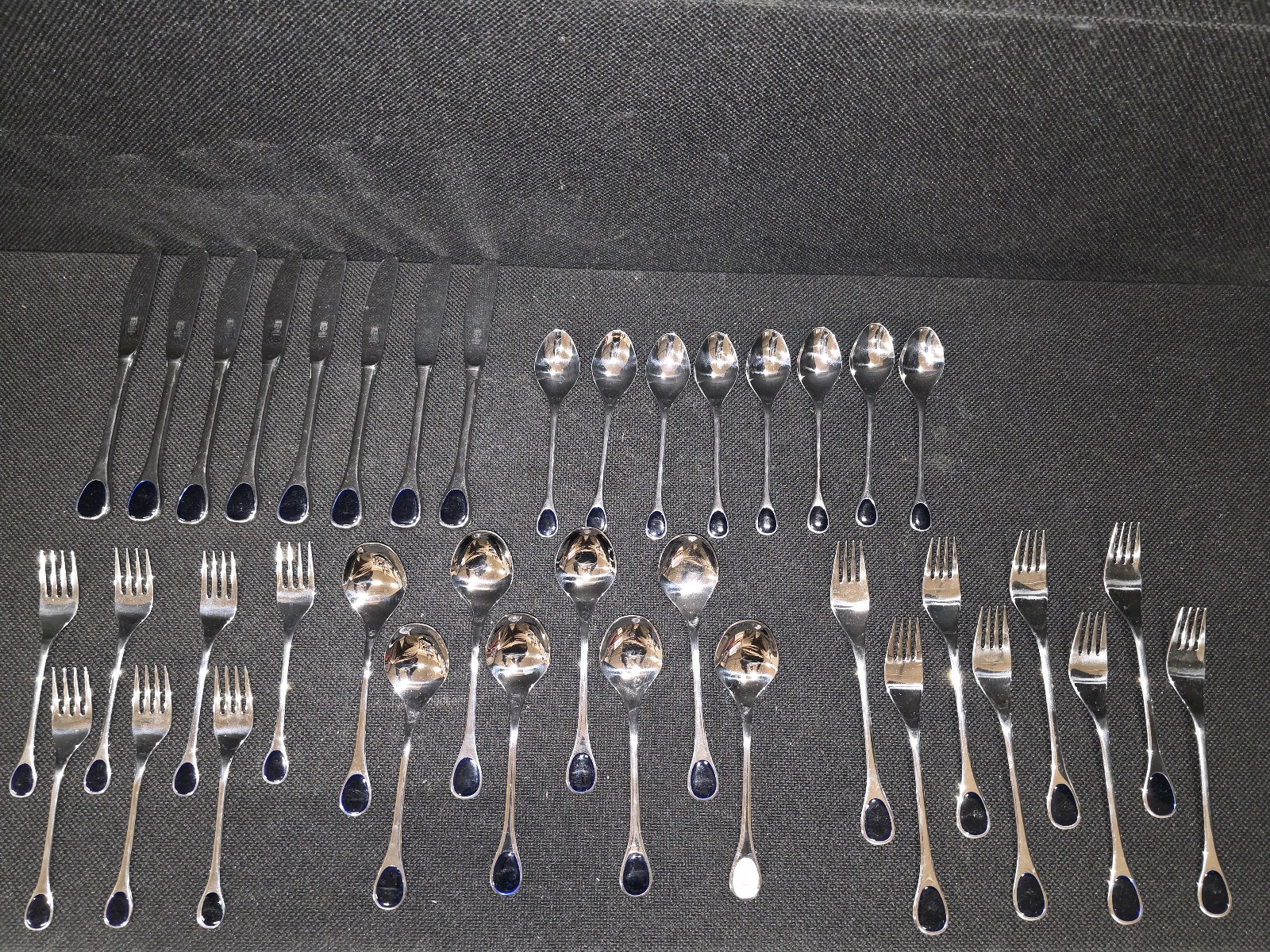 lot 175 image: Vintage Frst Besteck Flatware (Silverware) set in the Happy Day pattern, featuring unique dark, rounded handles.