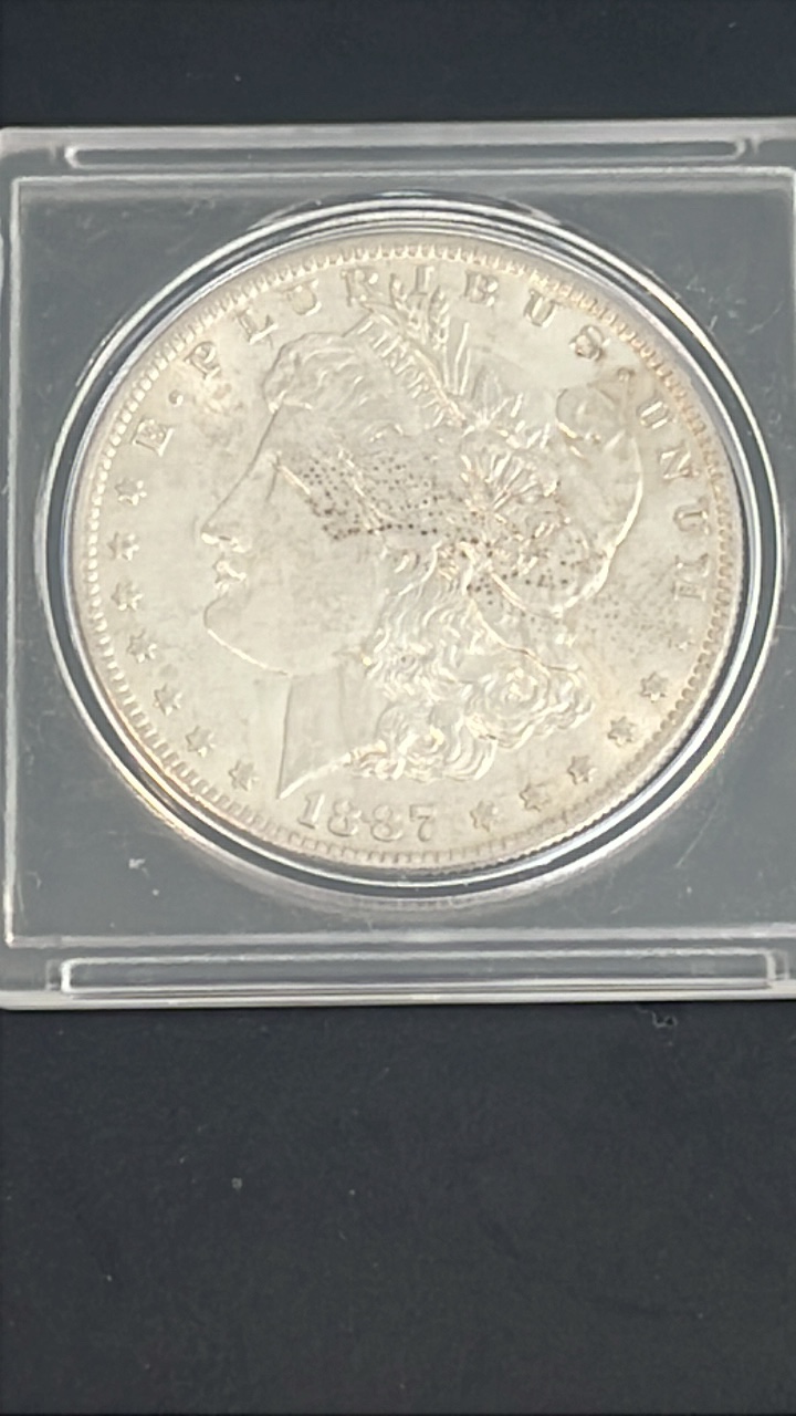 lot 13 image: 1887-O uncirculated Morgan Silver Dollar