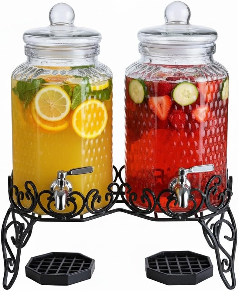 lot 141 image:  Two Glass Beverage Dispensers. Each one Can Hold 2-Gallons of Liquid, Great for Punch, Water, Lemonade, Adult Beverages, and More. Great for Home Use, Commercial Use, Parties, Weddings, and Other Events.