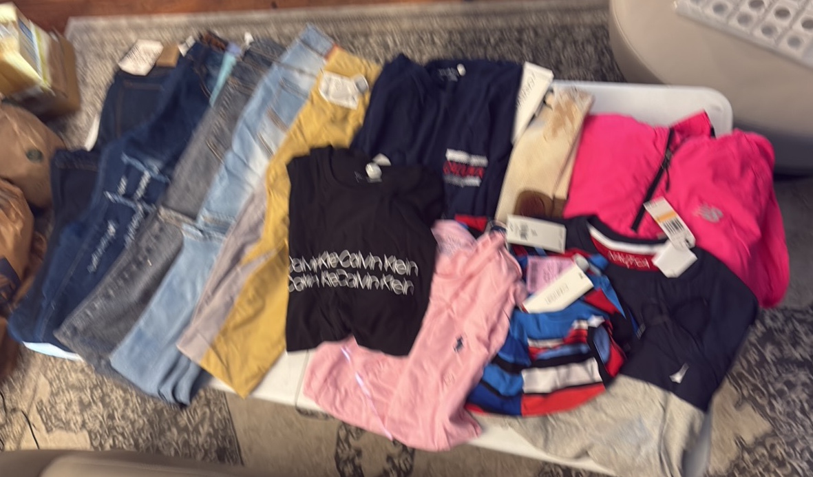 lot 94 image: (4) PAIRS of jeans, leggings, (3) Calvin Klein shirts, Nautica shirt, and new balance wind breaker