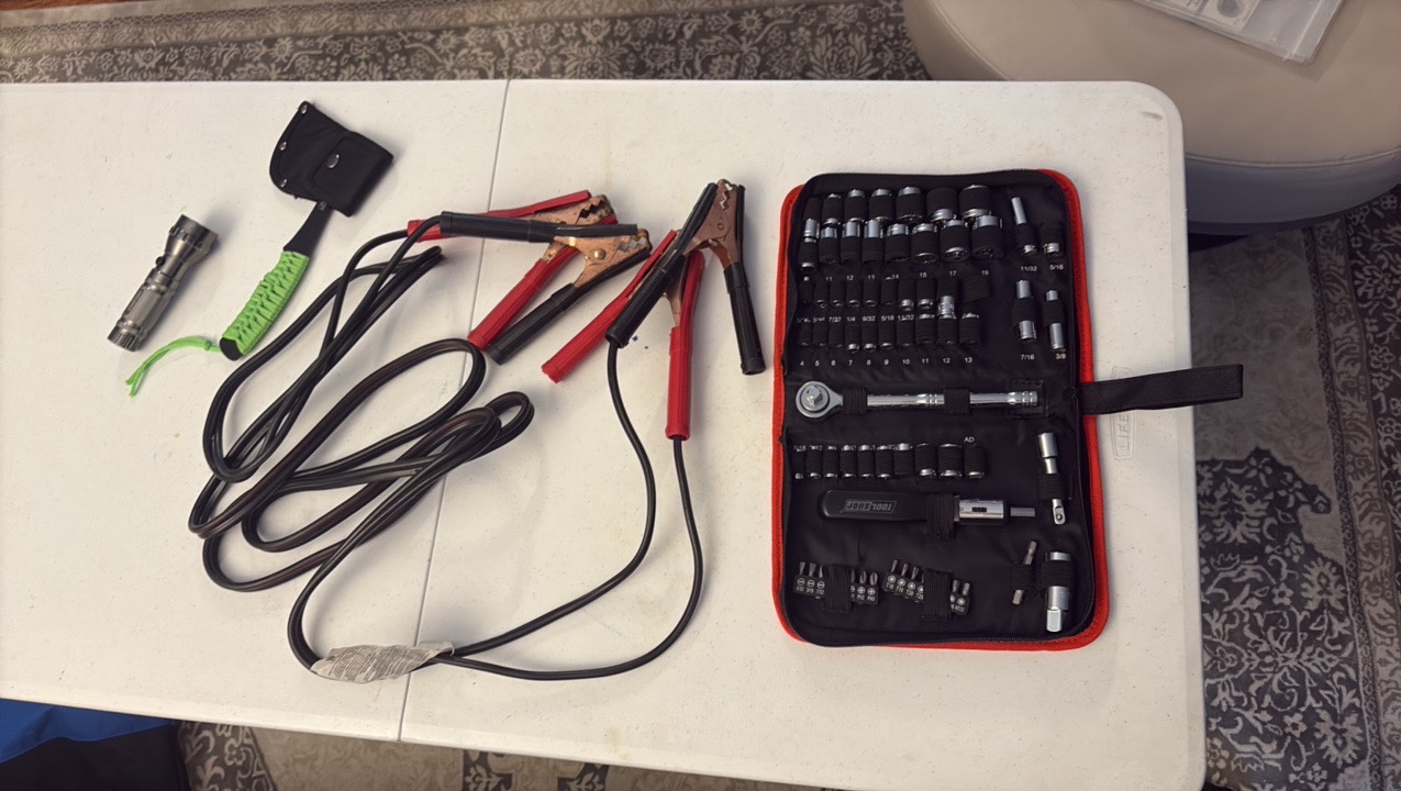 lot 95 image: SOCKET set, jumper cables, axe, and flash light