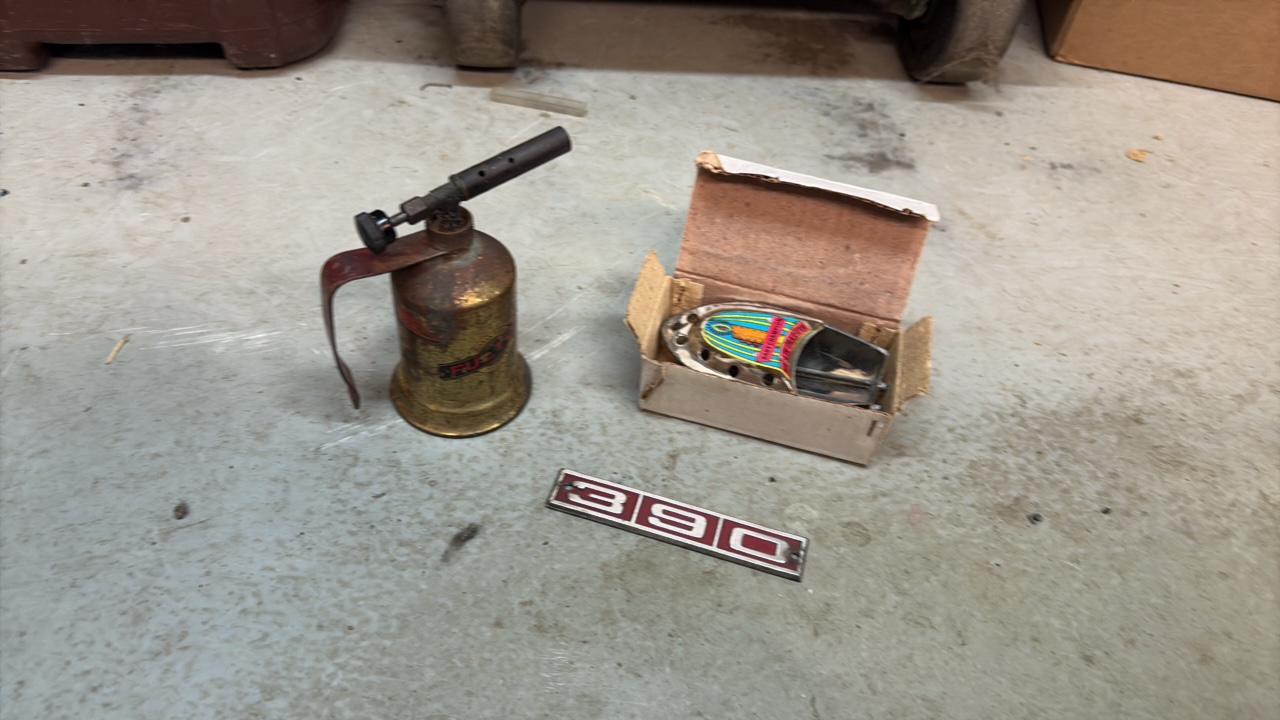 lot 259 image: Vintage collectibles Fulton torch, Ford Galaxy metal emblem, and baby champion boat