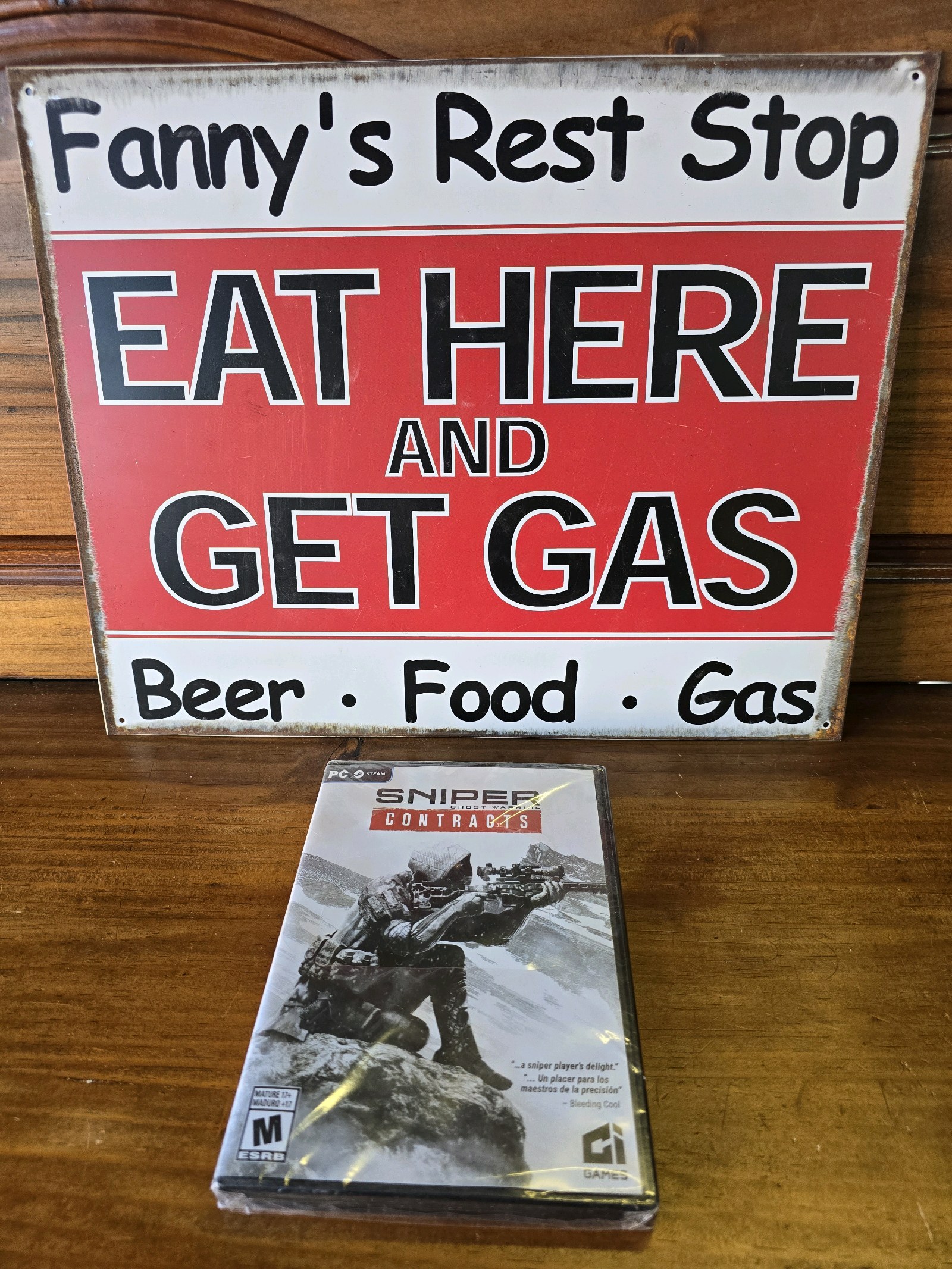 lot 36 image: Fanny Rest Stop Tin Sign & Sniper Contracts PC Game