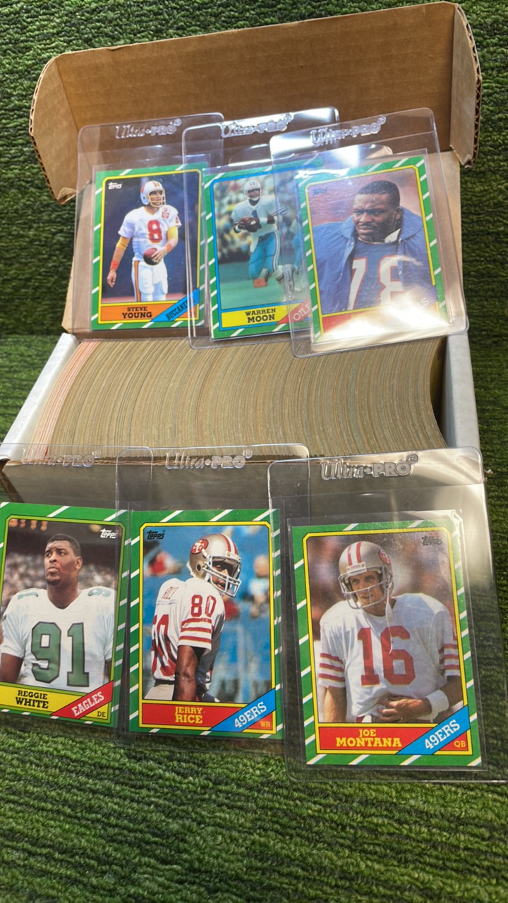 lot 115 image: 1986 Topps NFL complete set(#1-396) Jerry Rice & Steve Young Rookies Iconic