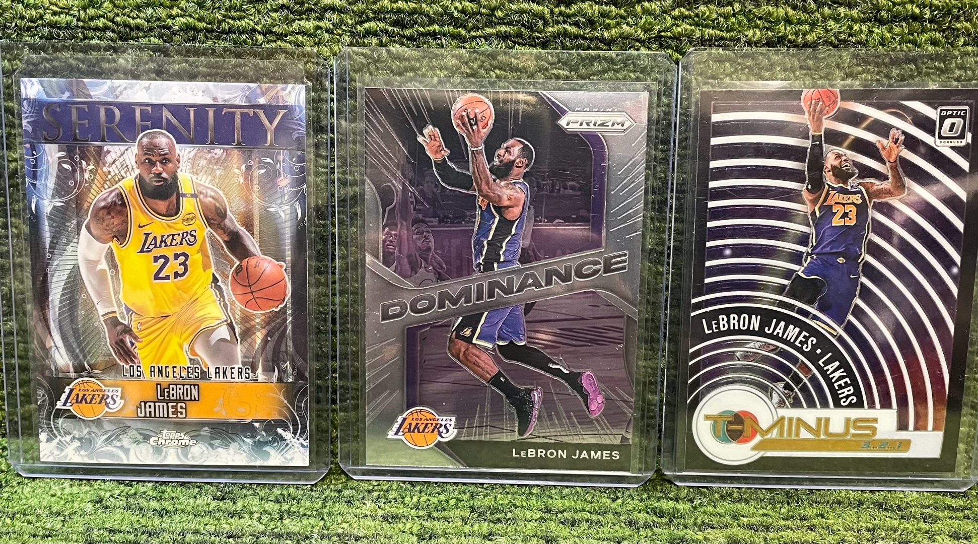 lot 148 image: LeBron James 3 Card Lot Serenity insert, 202-21PRIZM Dominance, & 2021 Optic T-Minus. L.A. Lakers