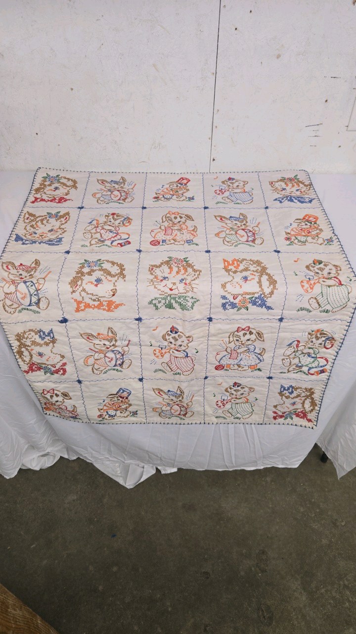 lot 14 image: Vintage Baby Quilt with cross stitching animals.