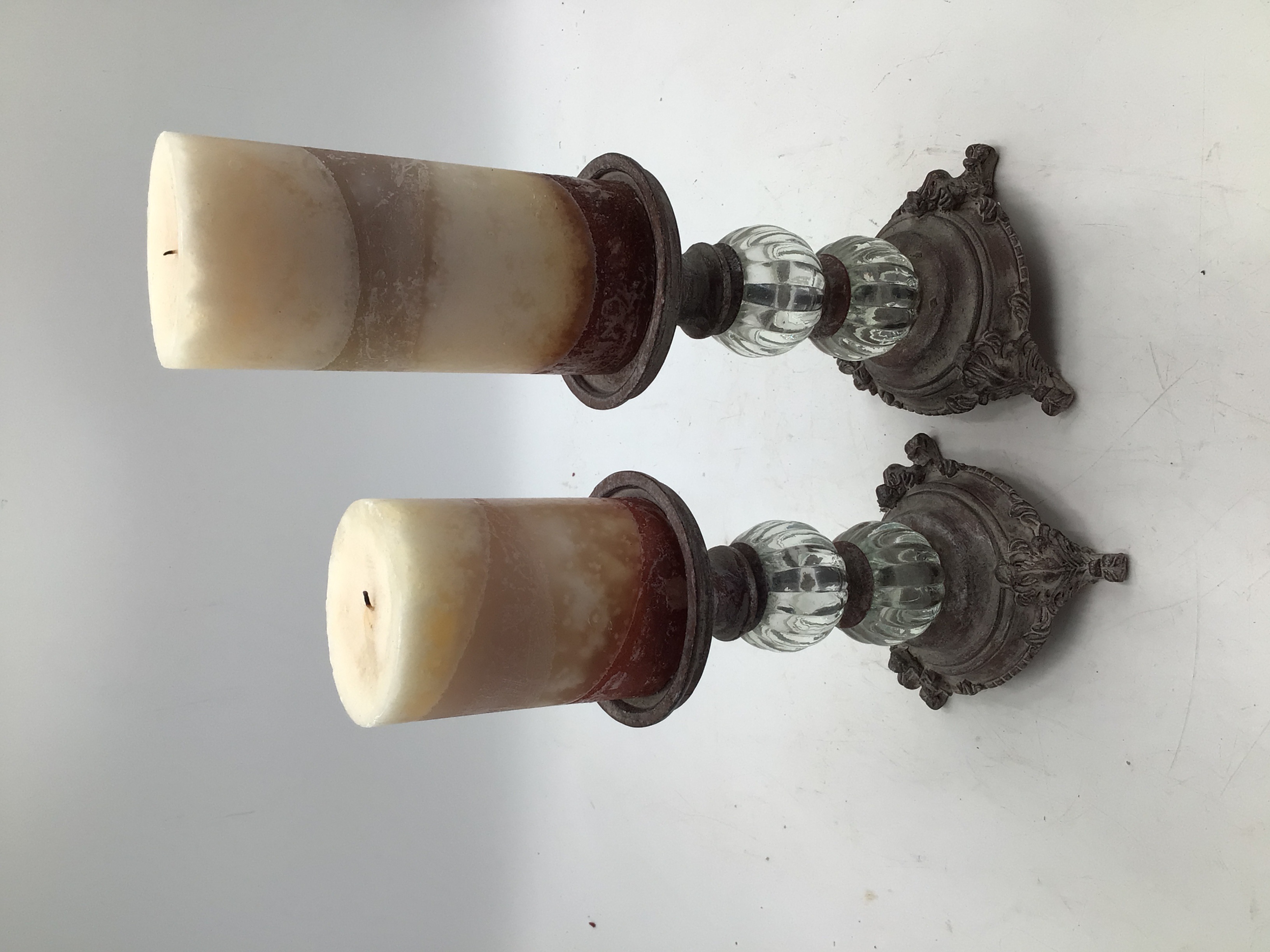 lot 27 image: 2 pillar candle holders with candles