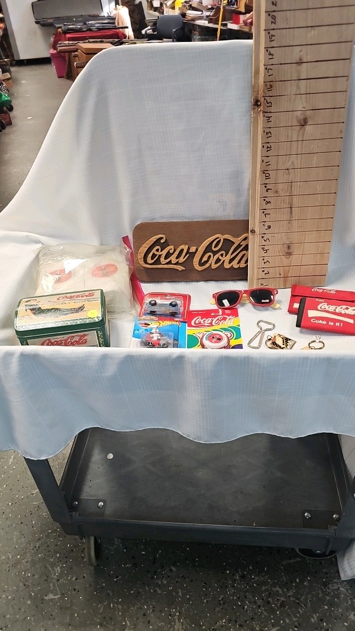 lot 72 image: Coca Cola Napkins, tins, wood dcor sign, wallets