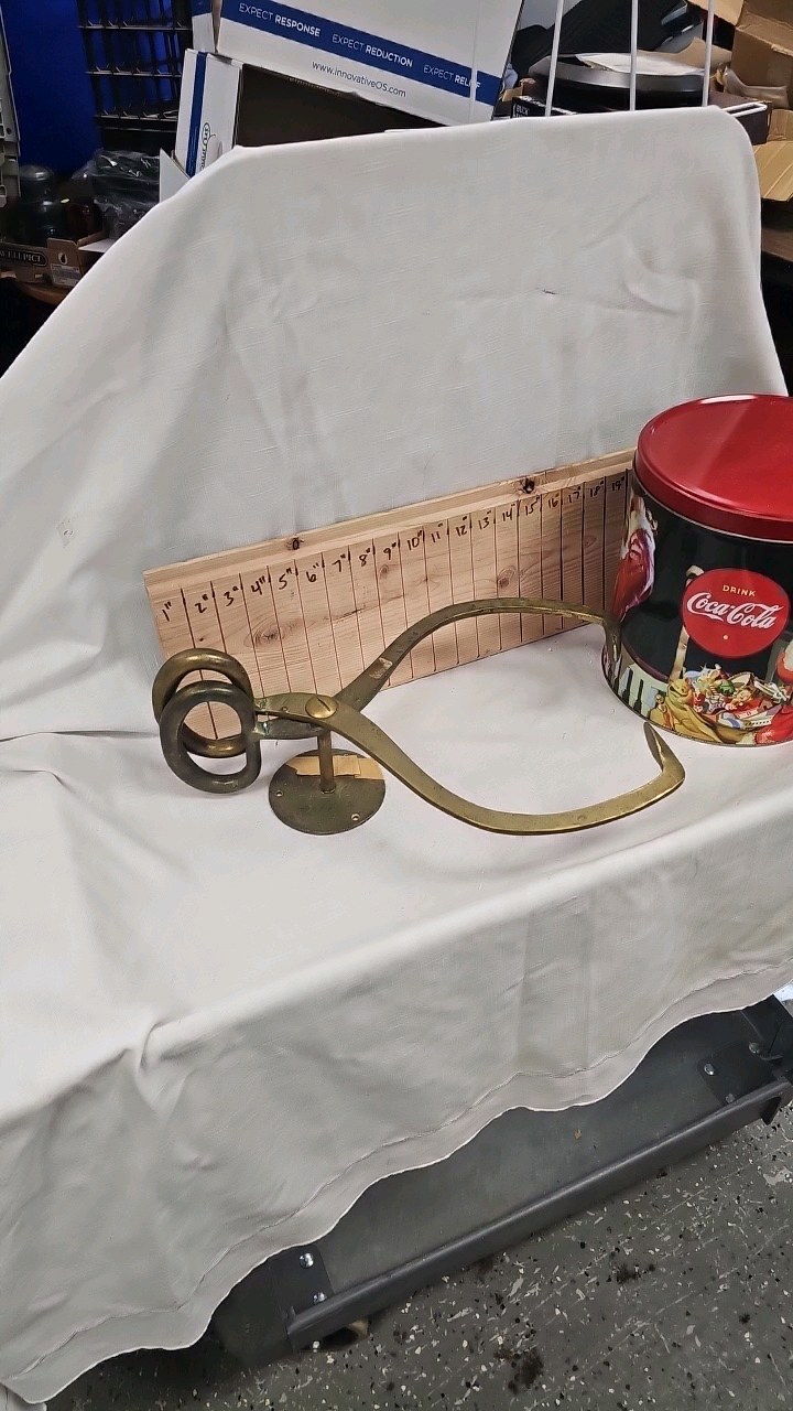 lot 79 image: Brass Ice Tong Paper Towel Holder and Coke Tin