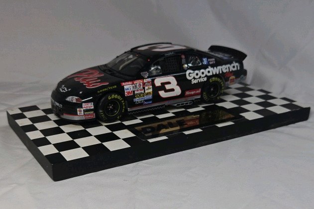 lot 114 image: Dale Earnhardt Sr. Goodwrench Monte Carlo  Black Diecast The 500 Daytona Win Replica on Checkered Base