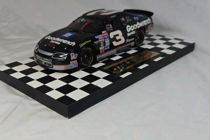 lot 116 image: Dale Earnhardt Sr. Goodwrench Monte Carlo  Black Diecast Bricks Brickyard Win Replica on Checkered Base