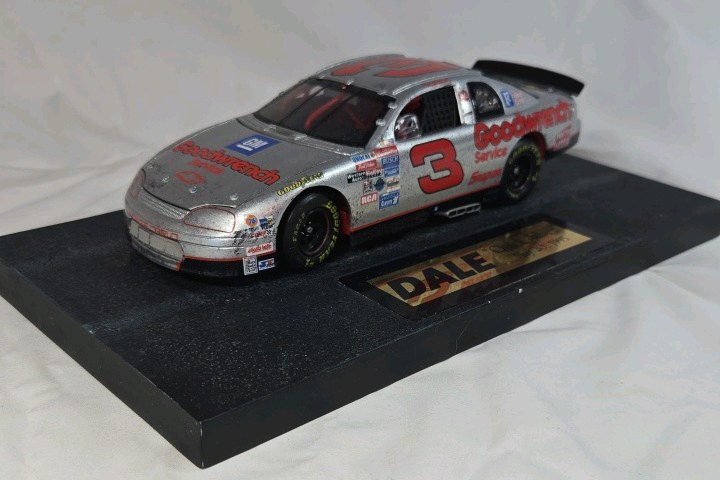 lot 117 image: Dale Earnhardt Sr. Goodwrench Monte Carlo  Silver Chrome Quick Silver Replica on Checkered Base