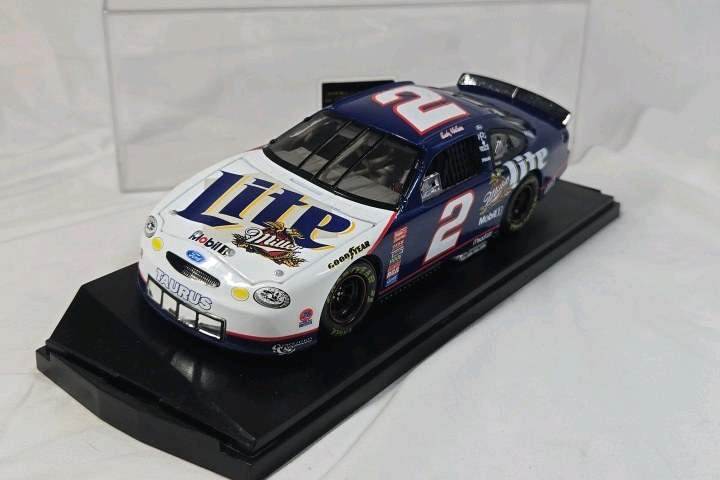 lot 129 image: Rusty Wallace Miller Lite Ford Taurus  Blue and White Diecast on Black Base