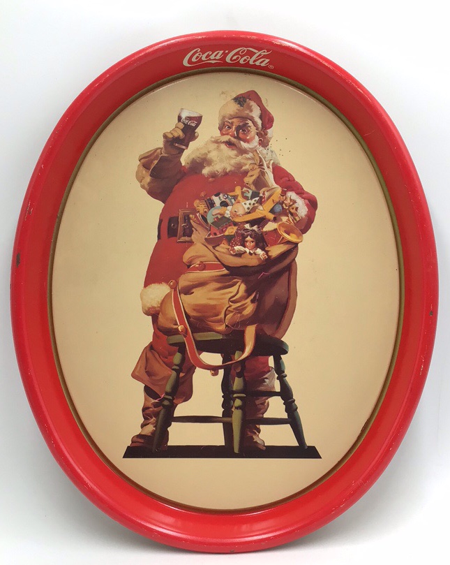 lot 169 image: Vintage Coca-Cola Santa Tray  Red Metal Oval with Santa Holding Coke & Toys