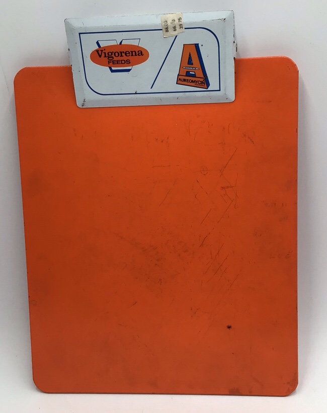 lot 180 image: Vintage Vigoreena Feeds  Aureomycin Clipboard  Orange Metal with Advertising Clip