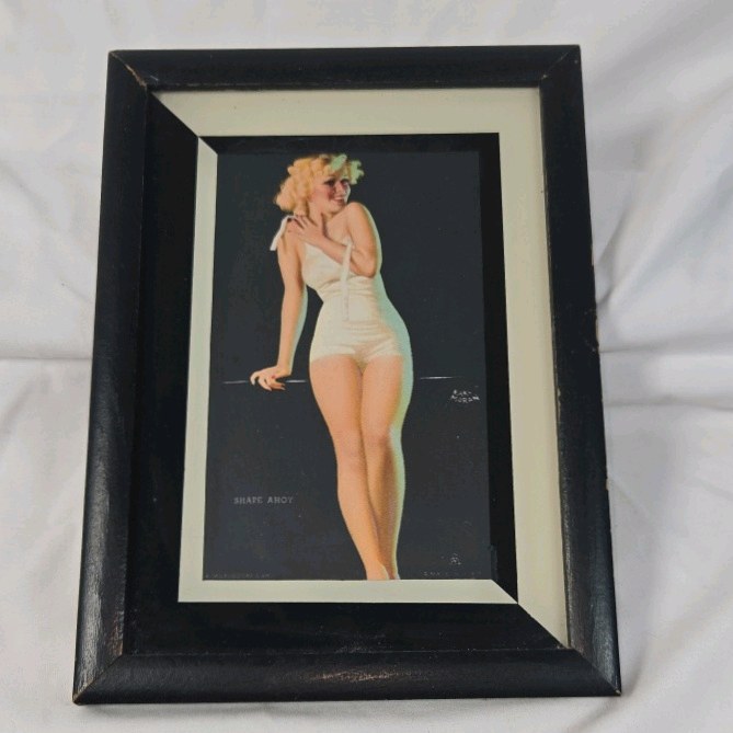 lot 225 image: Framed Earl Moran Pin-Up Print  Shape Ahoy Blonde in White Swimsuit