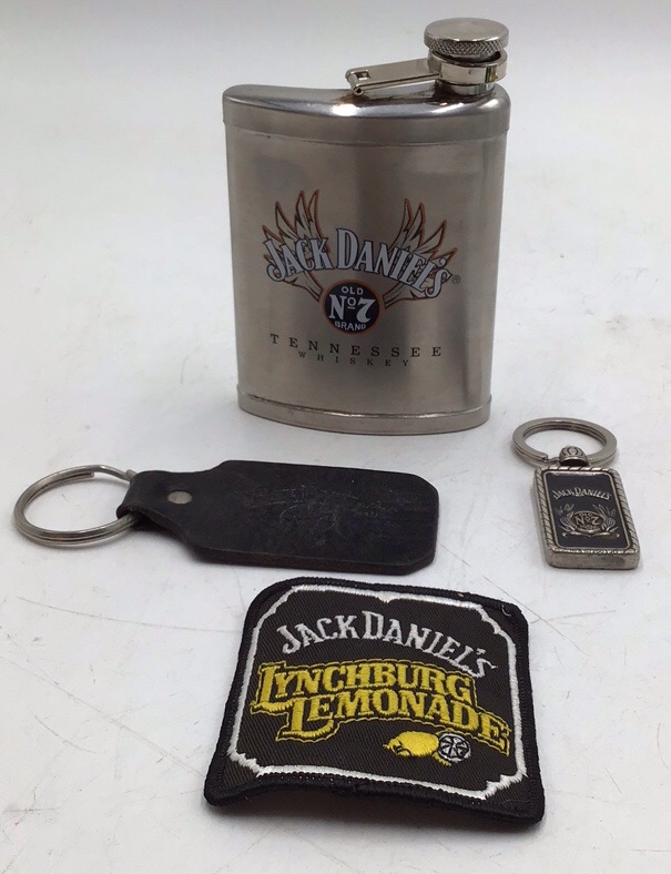 lot 9 image: Vintage Jack Daniels Flask with Keychains and Patch  Old No. 7 and Lynchburg Lemonade
