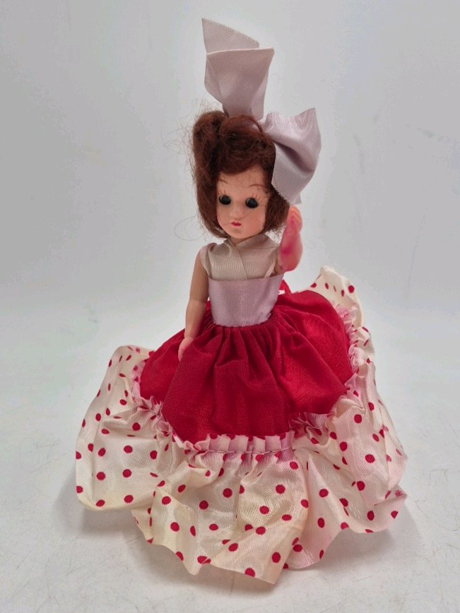lot 234 image: Vintage Small Brunette Vinyl Doll  Red Polka Dot Dress Large Bow