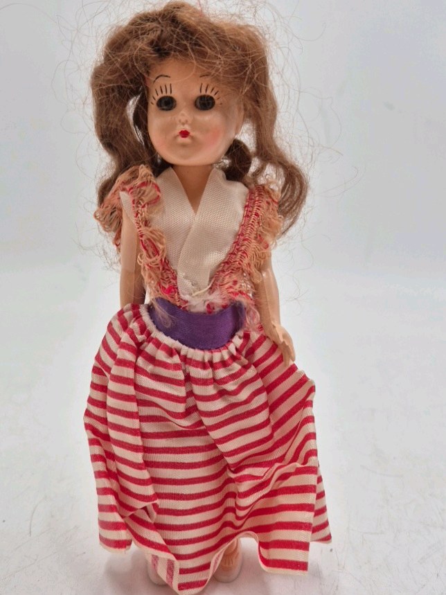 lot 235 image: Vintage Small Vinyl Doll  Striped Red White Dress Fringed Top Pigtails