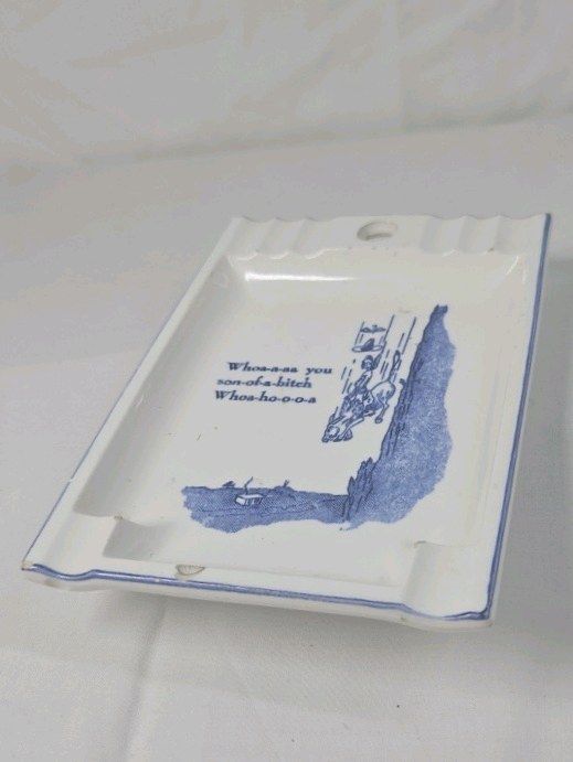 lot 278 image: Vintage Humorous Ceramic Ashtray  Cowboy Falling Off Cliff Cartoon Blue Print