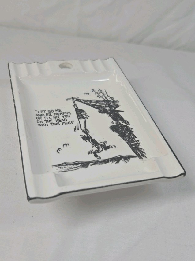 lot 279 image: Vintage Humorous Ceramic Ashtray  Lumberjack Hanging from Tree Cartoon