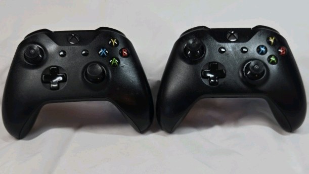 lot 98 image: Pair of Black Xbox One Wireless Controllers