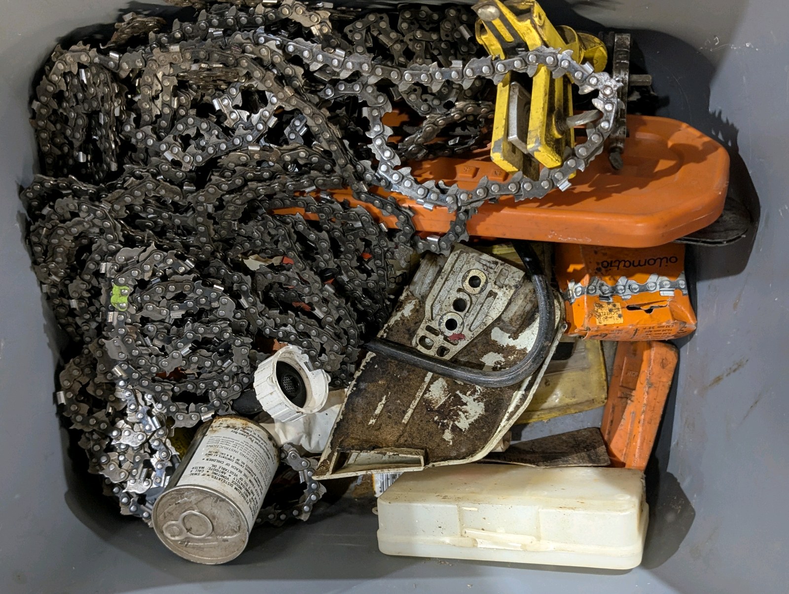 lot 74 image: Stihl Chainsaw Parts & Chain Lot  Multiple Chains, Sharpeners, Parts, Case & Spotlight