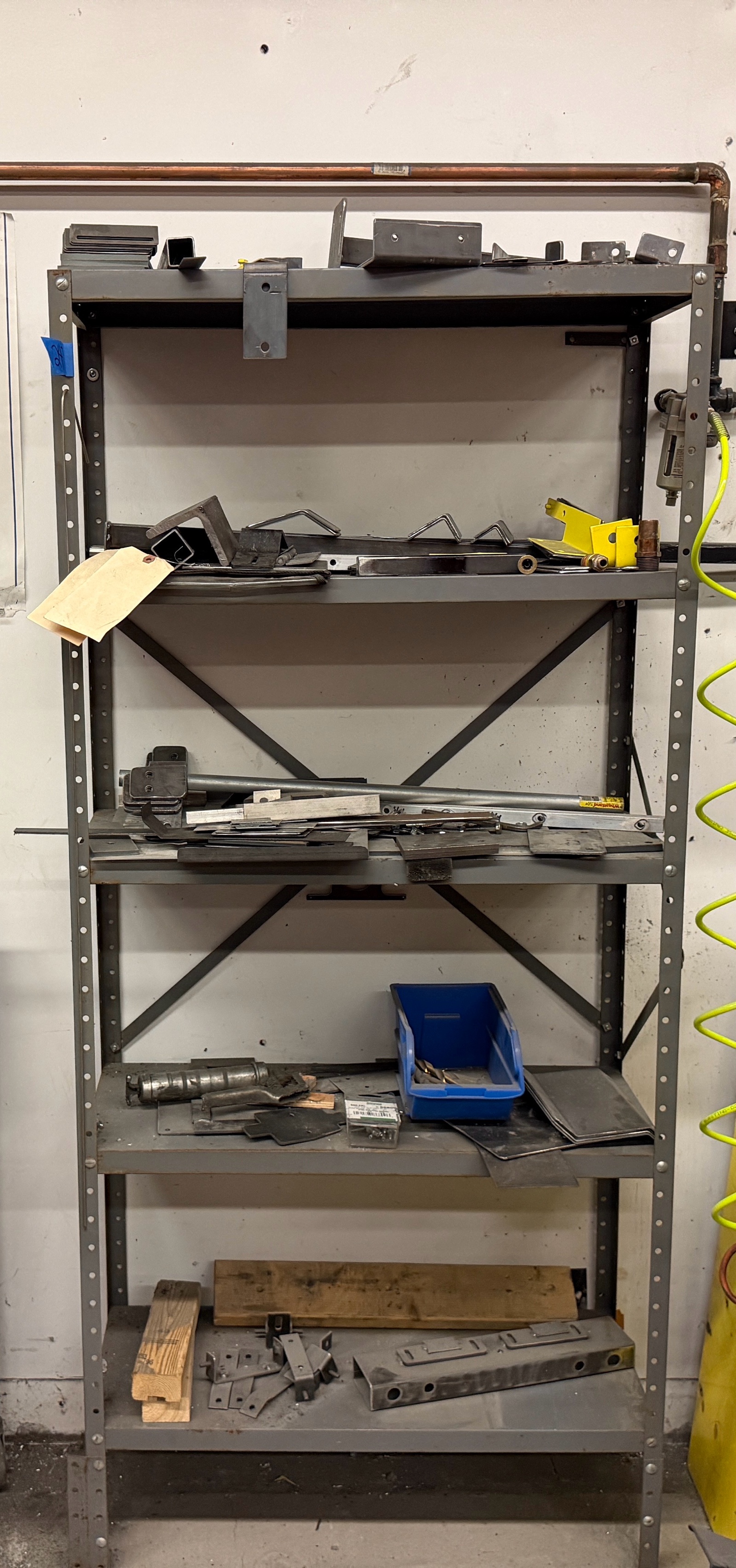 Metal 5-shelf unit with contents.