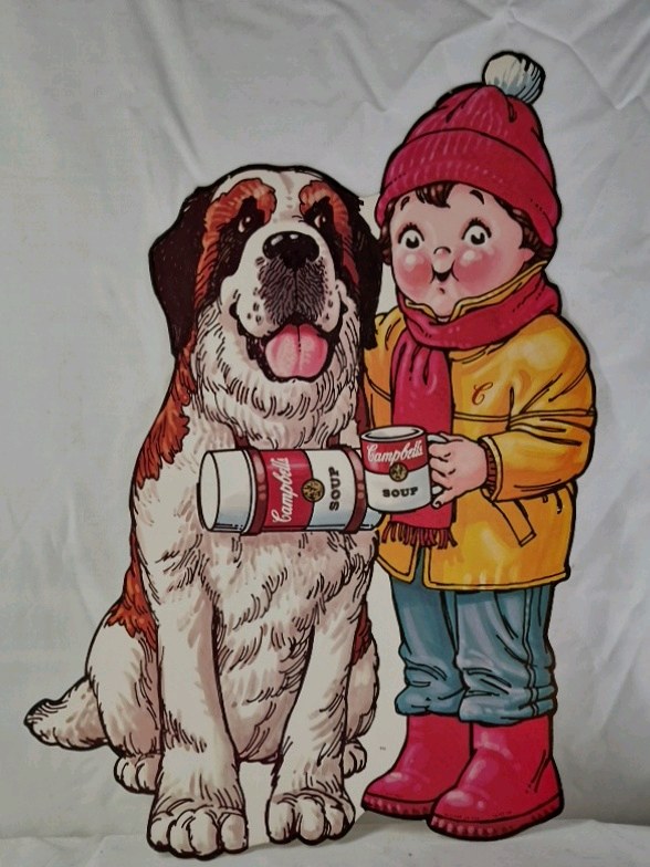 lot 17 image: Vintage 1980s Cardboard Cutout  Campbells Soup Kid with St. Bernard Dog