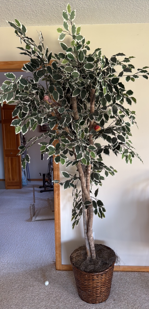 Artificial tree in pot with birds in the leaves