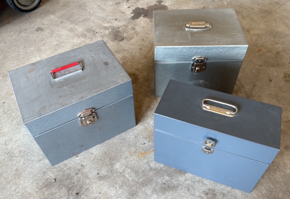 three metal file boxes
