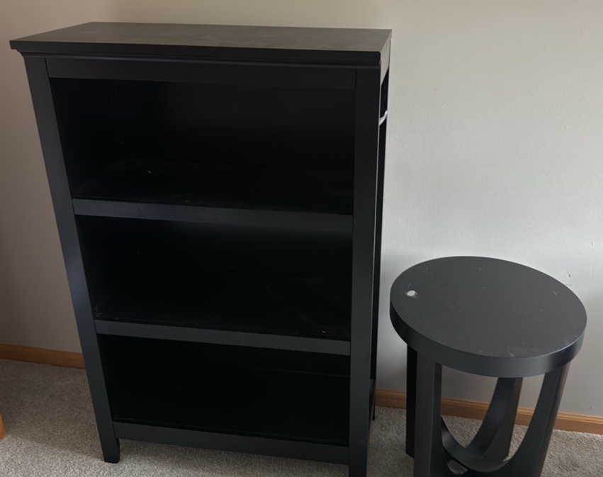 Black solid bookcase and round table