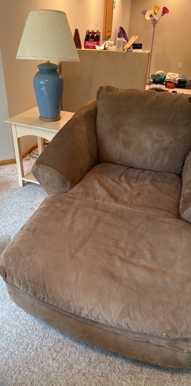 Suede style material Chase lounge with end table and blue lamp