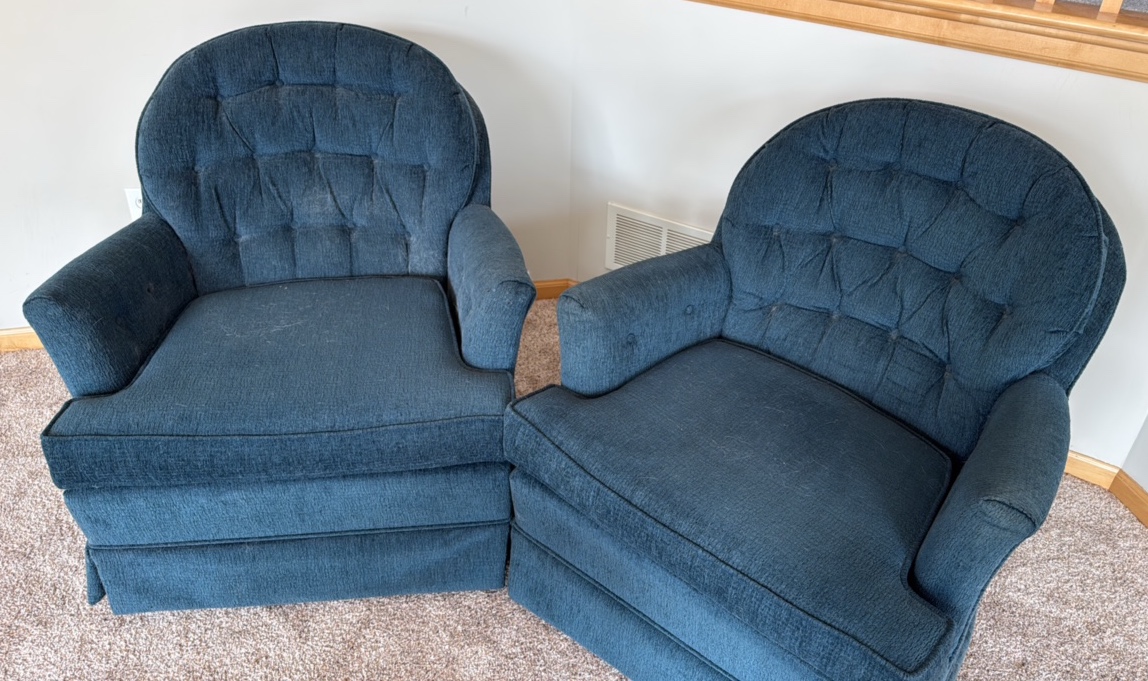 two blue upholstered barrel styled chairs