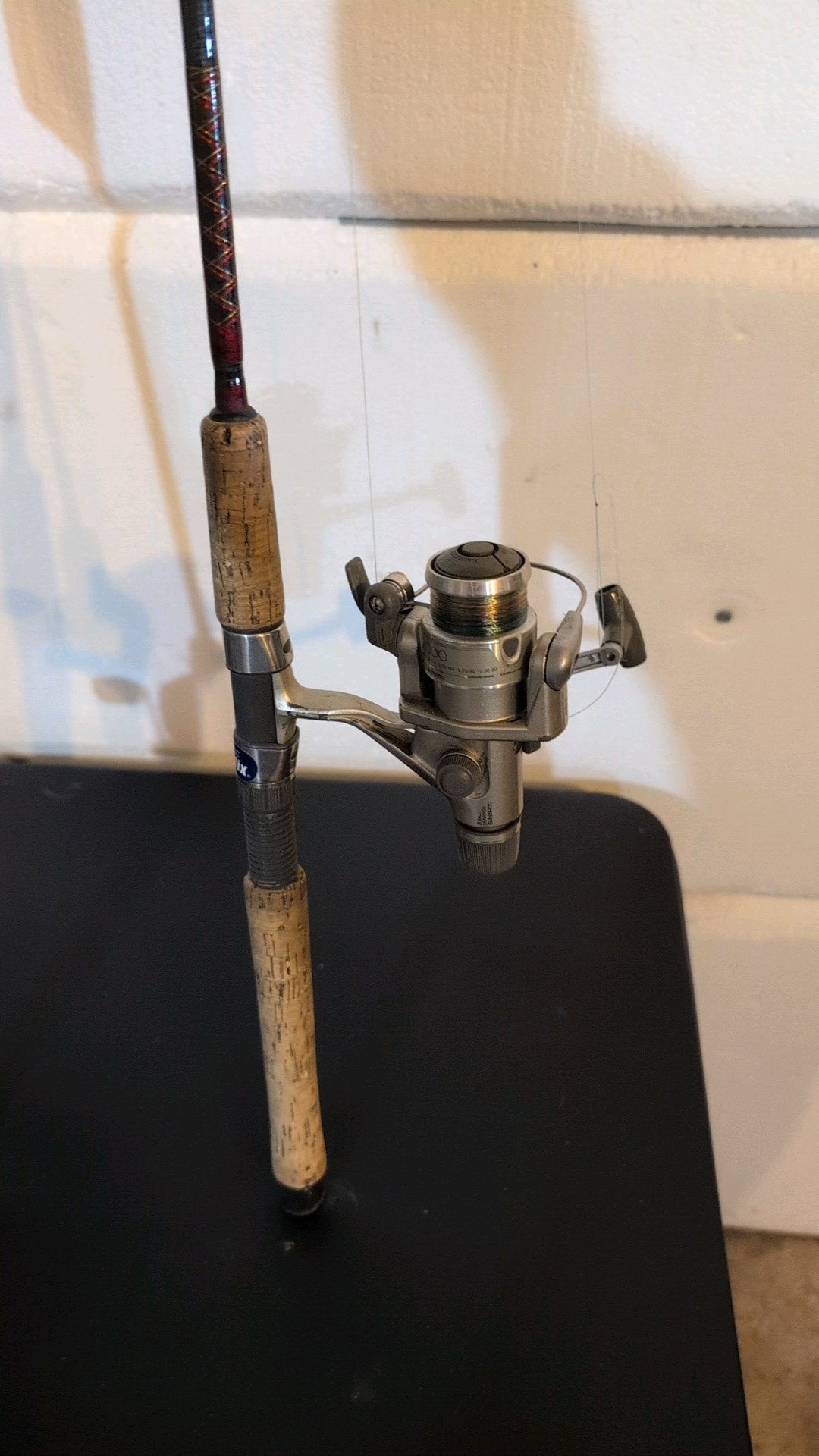 two fishing poles one still has a tag