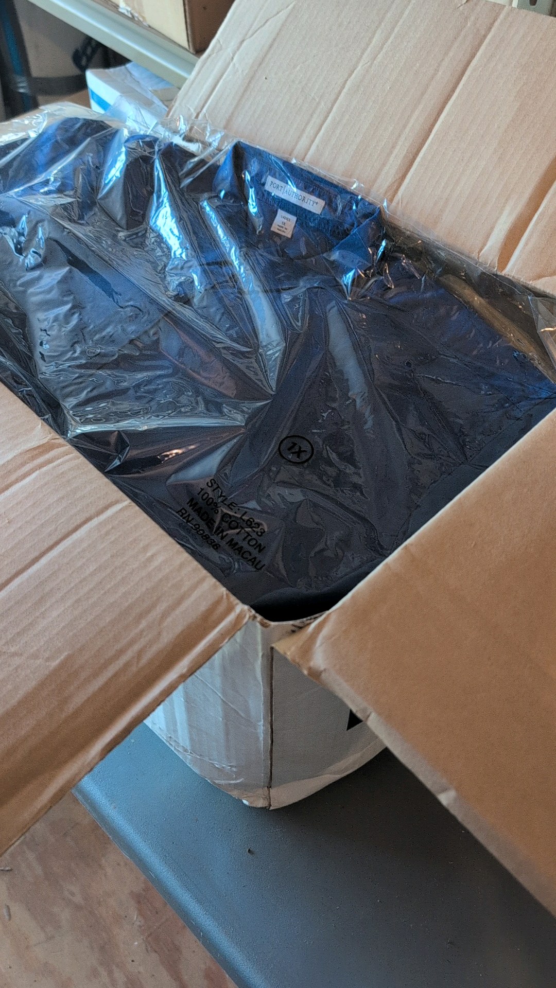 box of button-up cotton shirts