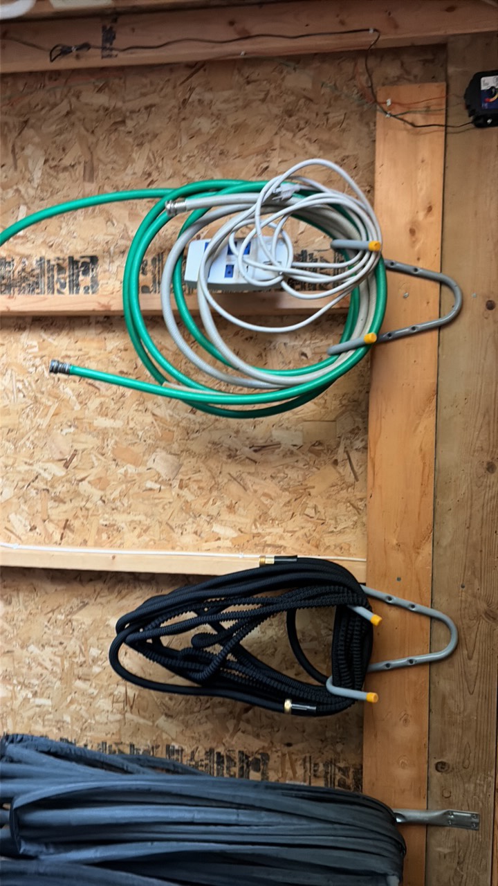 lots of garden hoses and Wall hangers