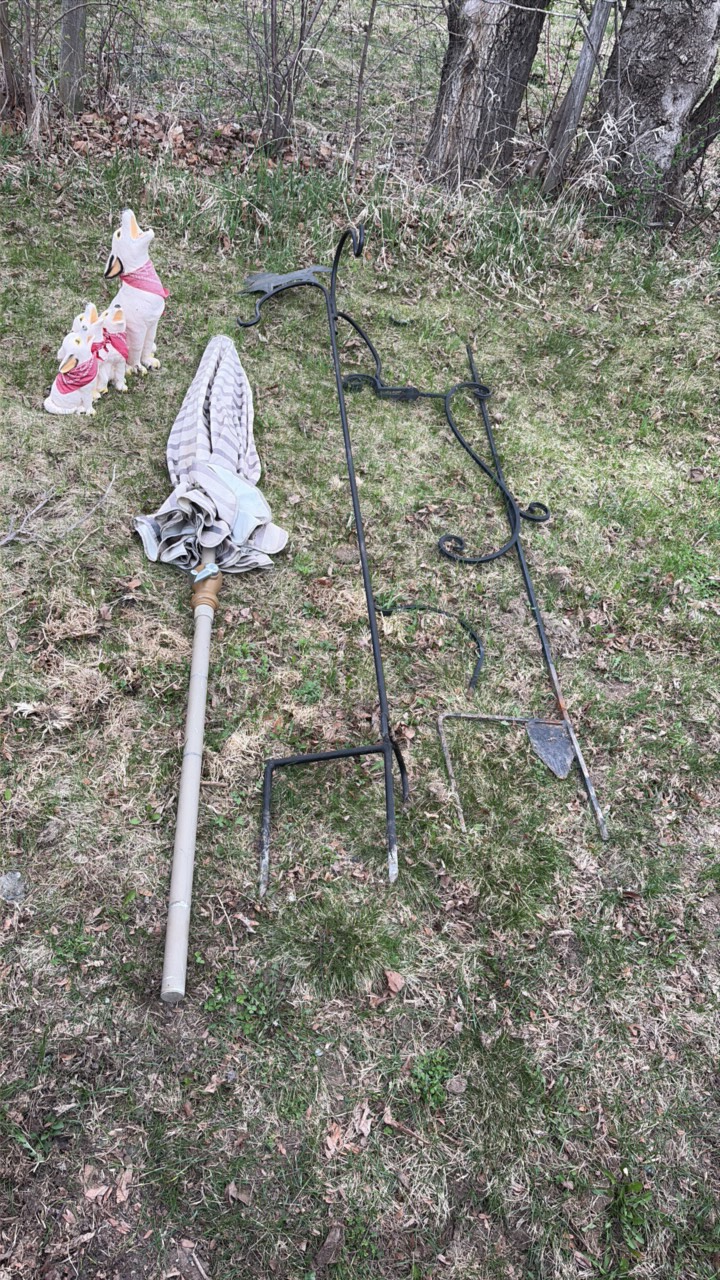 lot of outdoor decorations, including an umbrella, howling, dog statues, and wind catchers