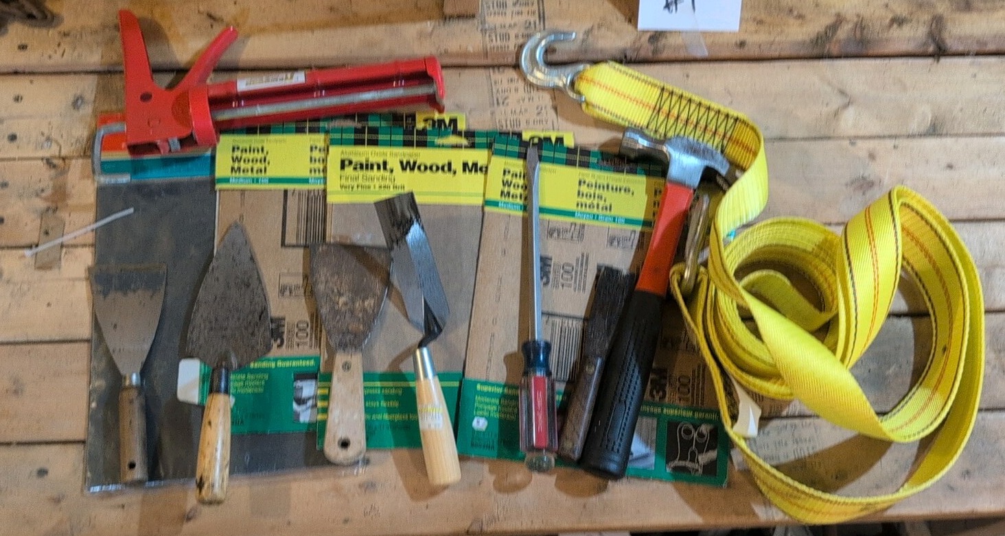 catch all masonry hand tools sandpaper and ratchet strap tie down