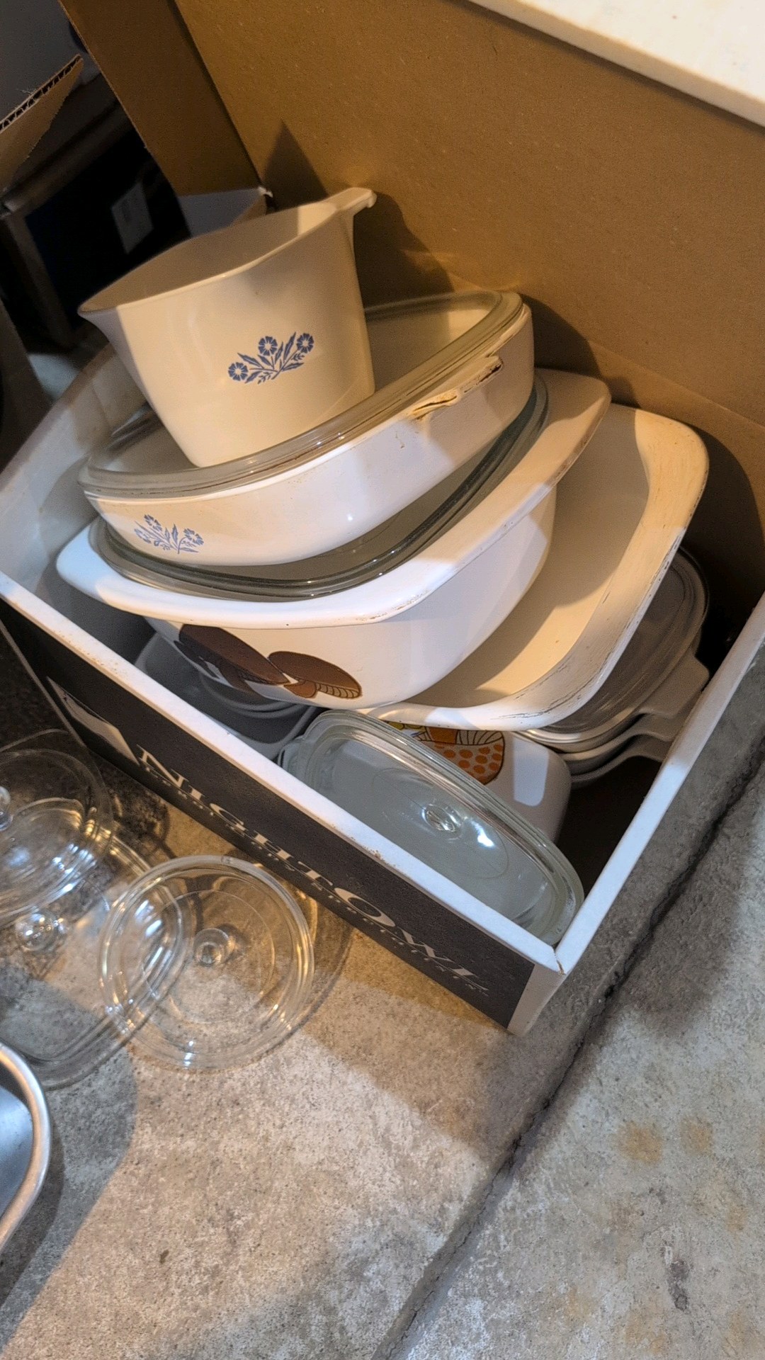 box of household dishware and pans
