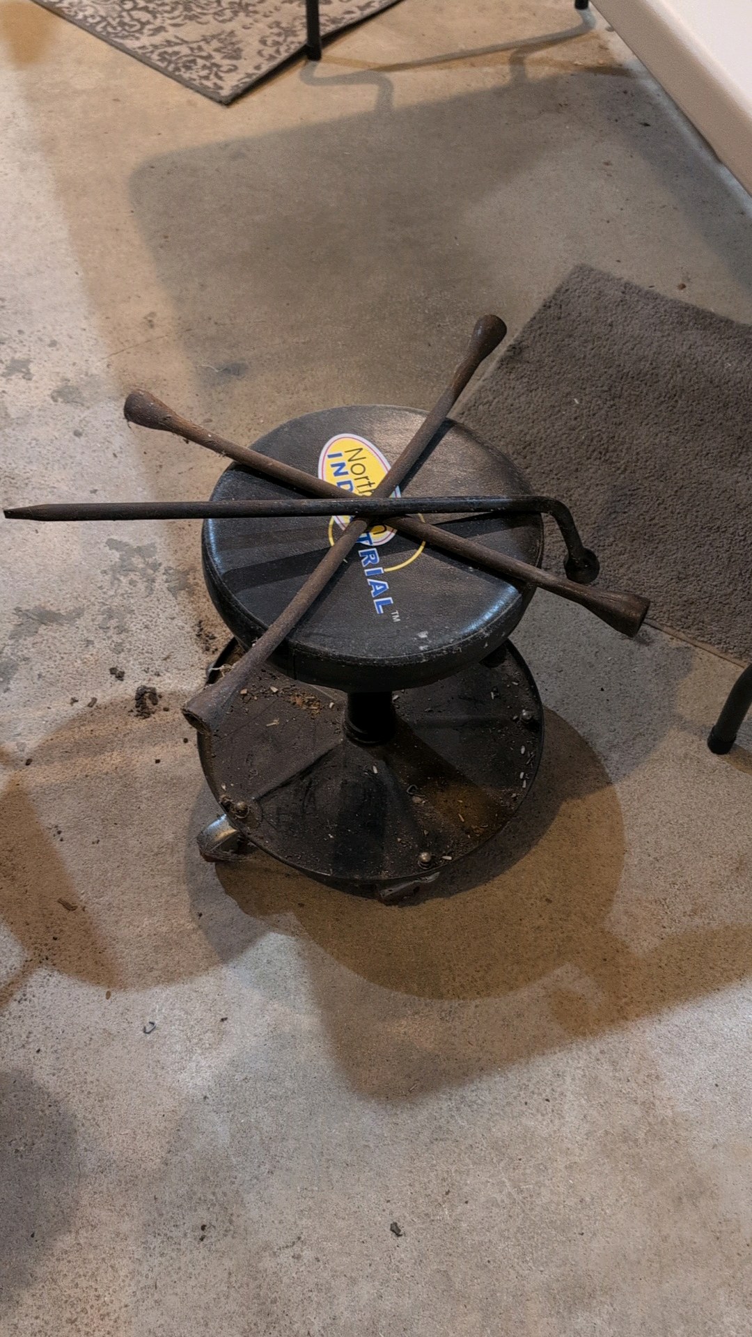 rolling mechanic bench and two wrenches