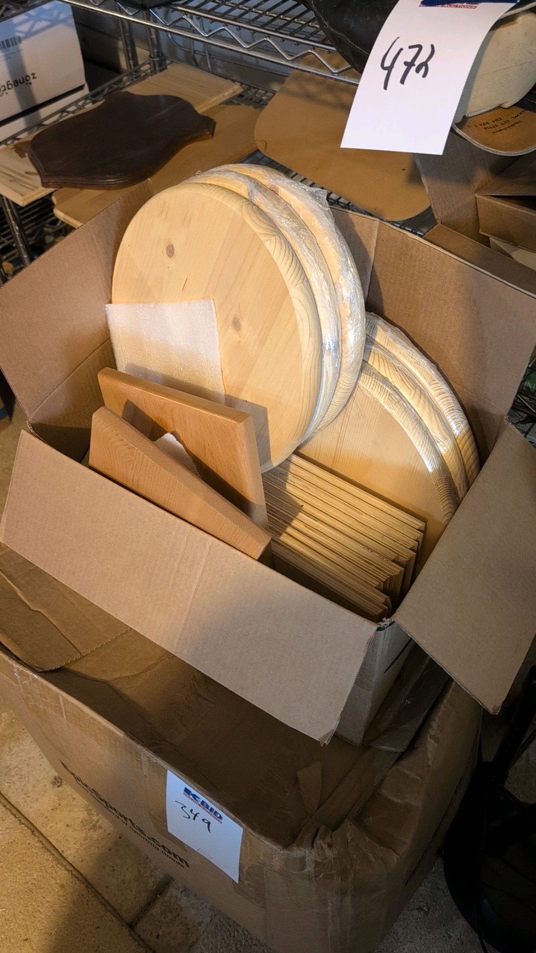two boxes of of wooden rounds and other wooden items